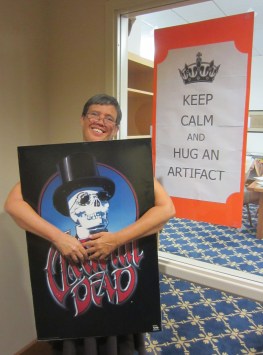 University Archivist, Jennifer Greene, "hugging" a Grateful Dead poster for National Archives Month, 2015. Source: James Wethington