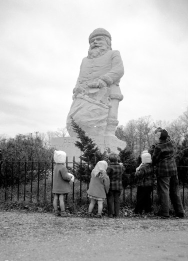 Children standing around Santa Claus statue, 1940. Source: Thomas Mueller collection, MSS 264.2174.
