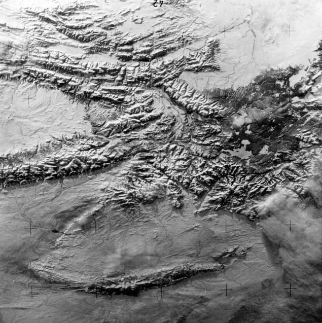 A near vertical view of the snow-covered northwest corner of Wyoming as seen from the Skylab space station in Earth orbit. A Skylab 4 crewman used a hand-held 70 mm Hasselblad camera to take this picture. A small portion of Montana and Idaho is in this photograph. The dark area is Yellowstone National Park. The largest body of water is Yellowstone Lake. The Absaroka Range is immediately east and northeast of Yellowstone Lake. The elongated range in the eastern part of the picture is the Big Horn Mountains. The Wind River Range is at bottom center. The Grand Teton National Park area is almost straight south of Yellowstone Lake. Approximately 30% of the State of Wyoming can be seen in this photograph, 1974. Source: Lee William Jones collection, MSS 244-0255.