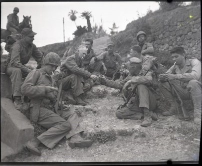 Pyle with a Marine patrol on the roadside in Okinawa, April 8, 1945. Source: https://bit.ly/2QTEFbR