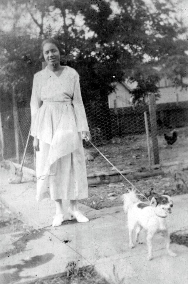 Girl walking a small dog