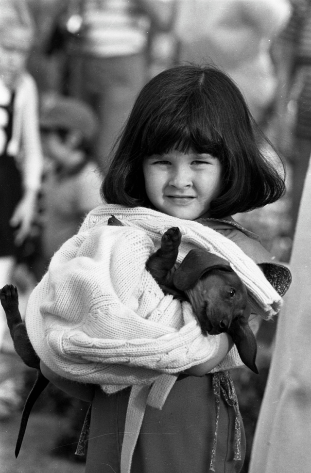 Girl with dog wrapped in a blanket